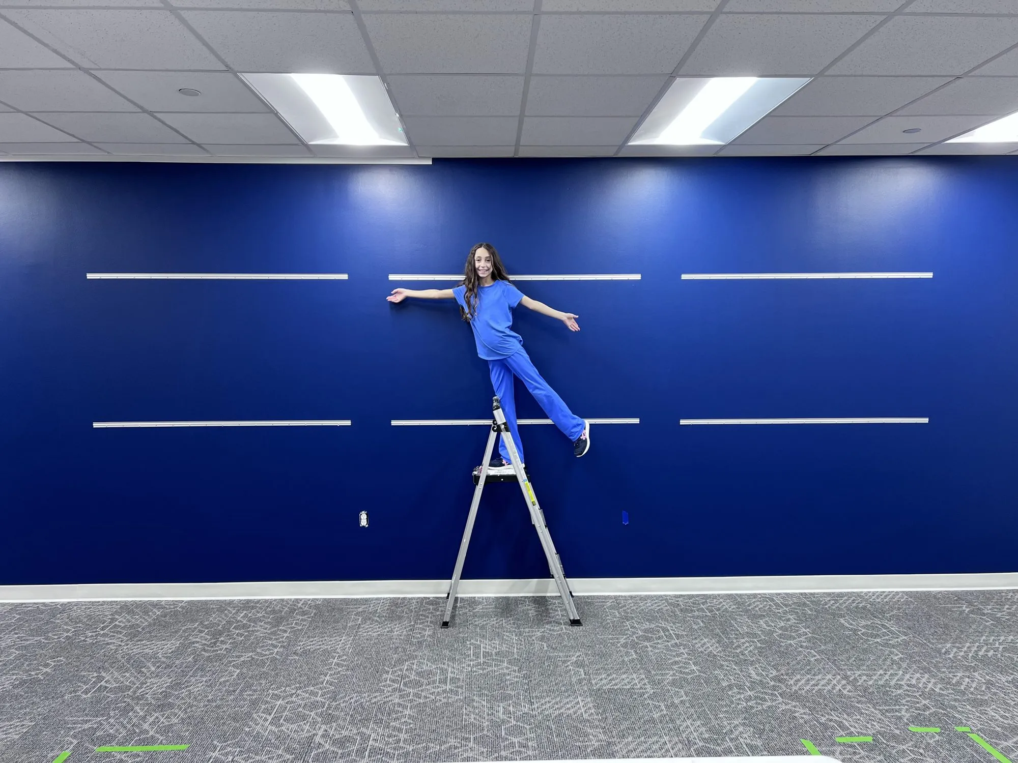 Olivia hanging whiteboards during the Sugar Land room build over Christmas break.
